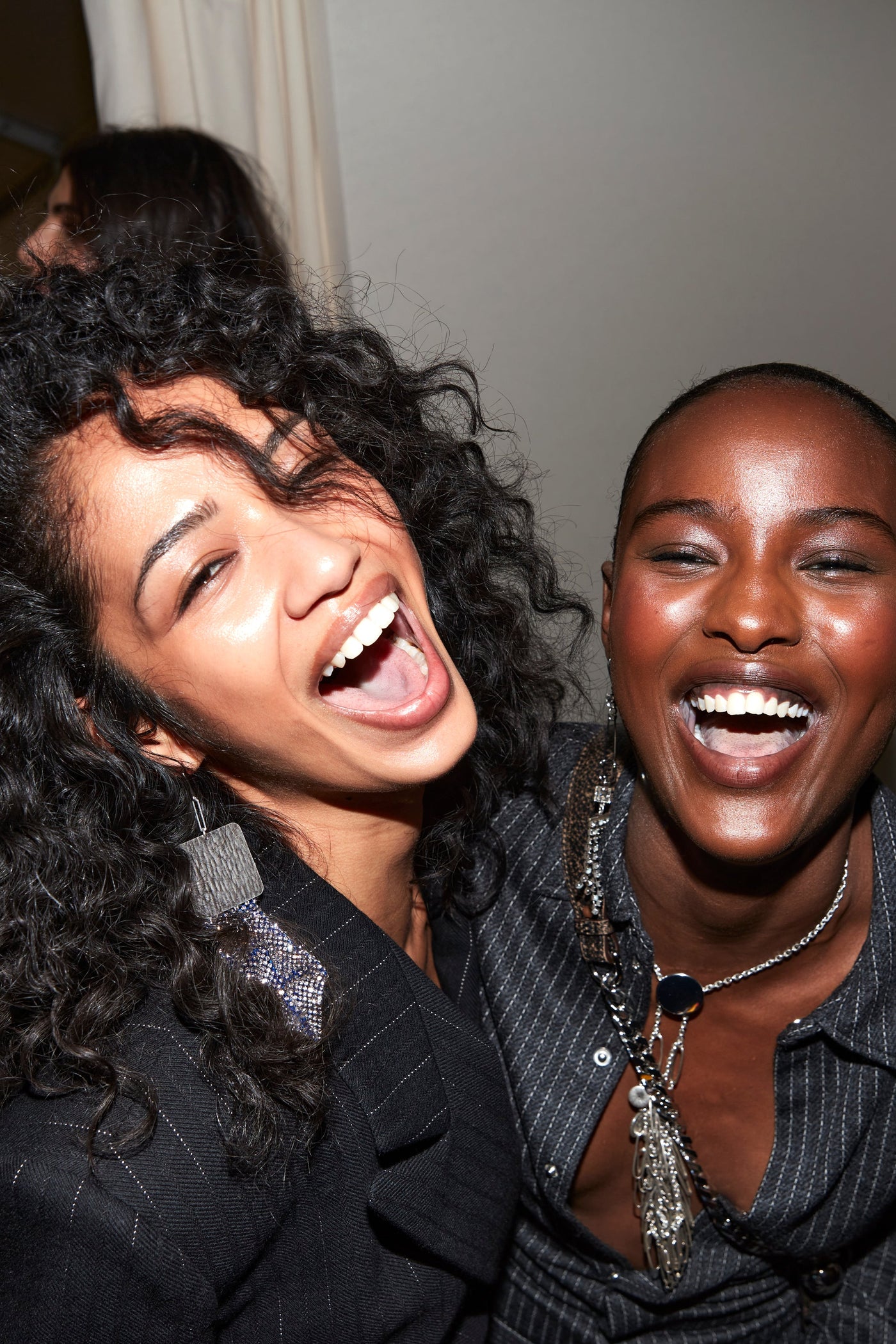 Laughing models are wearing the Maia jacket and Romea anthracite striped shirt both styled with silver jewels