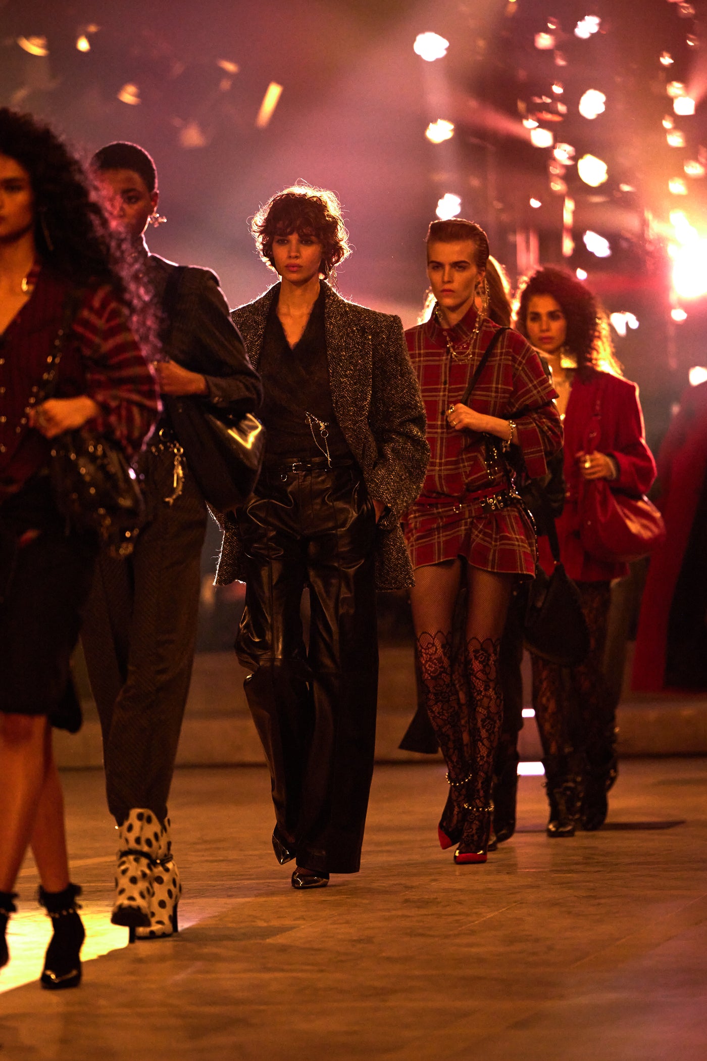 Models are wearing grey coat withblack leather pants and Plaid cotton shirt dress with lace tights.