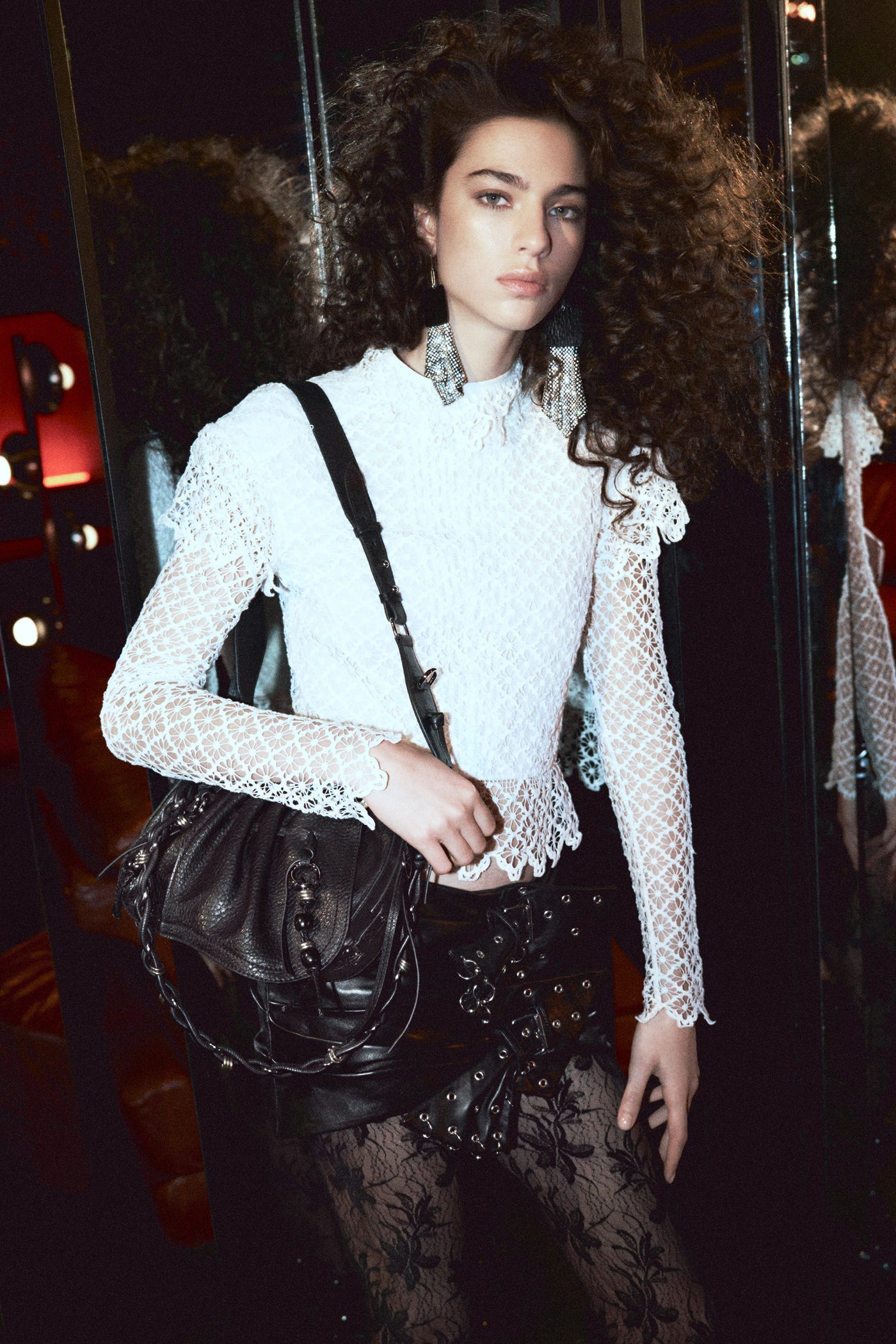 Model in white lace top with the Bolton bag and skirt in leather