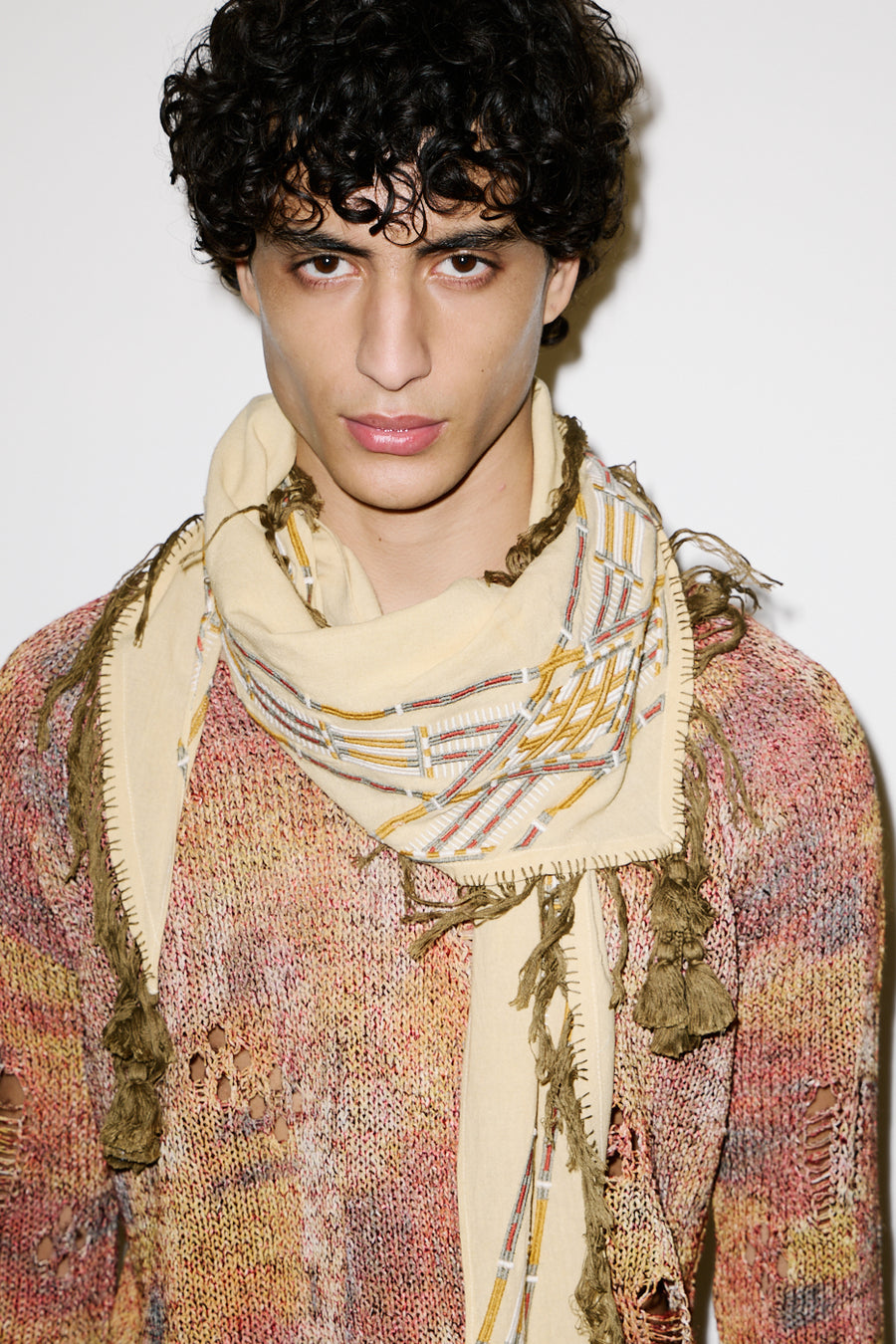 Models wears an orange sunset tones knitwear top with the Fizzio sunlight scarf
